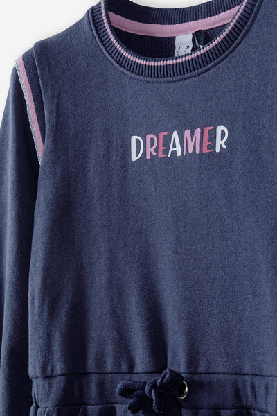 A navy blue knitted dress with the Dreamer inscription